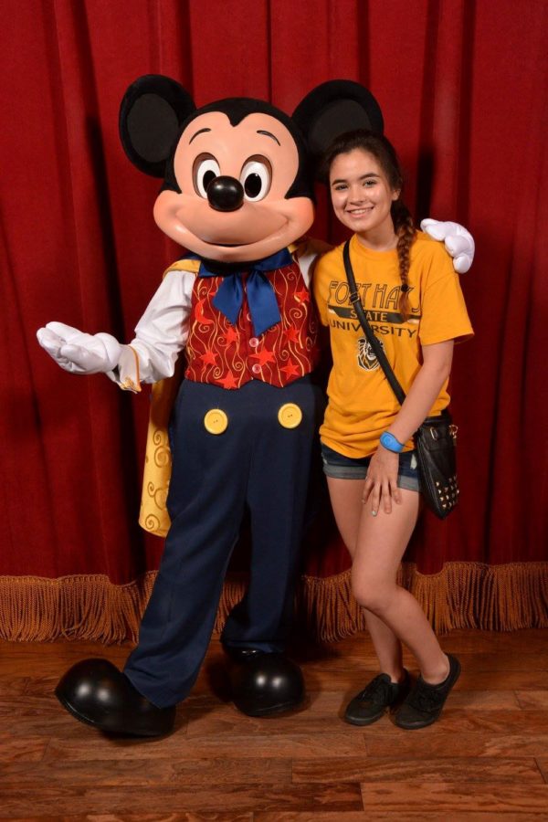 Nayeli Ochoa takes a picture with Mickey Mouse in Disney World